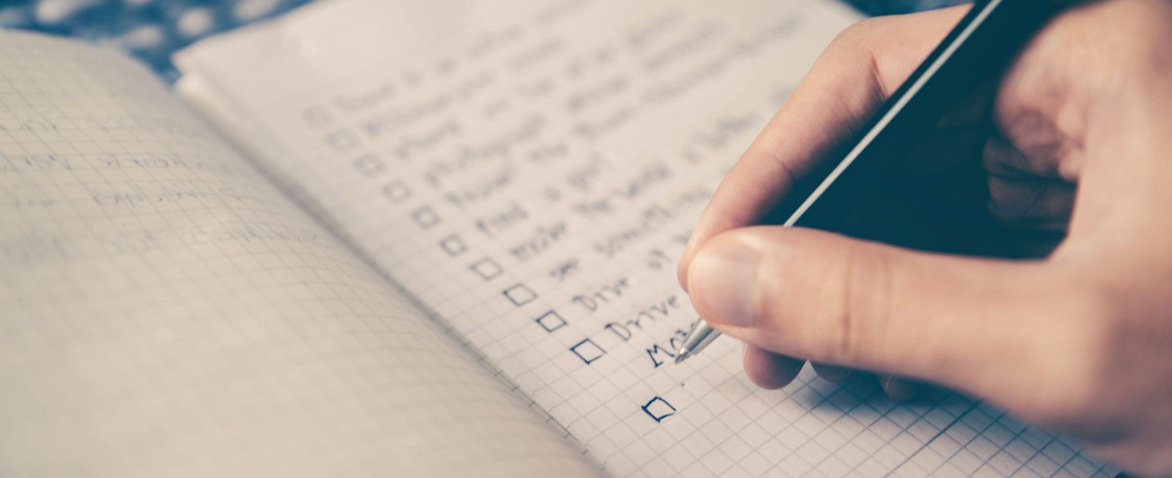 A person writing on a notebook